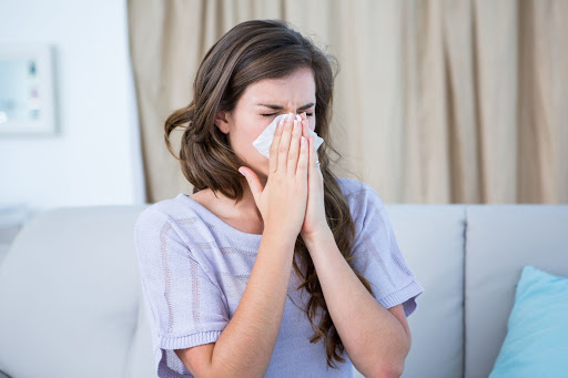 woman sneezing aaa cooling